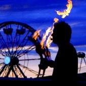 Paul Isaak Juggling Fire, in front of Ferris Wheel at Tanana Valley State Fair